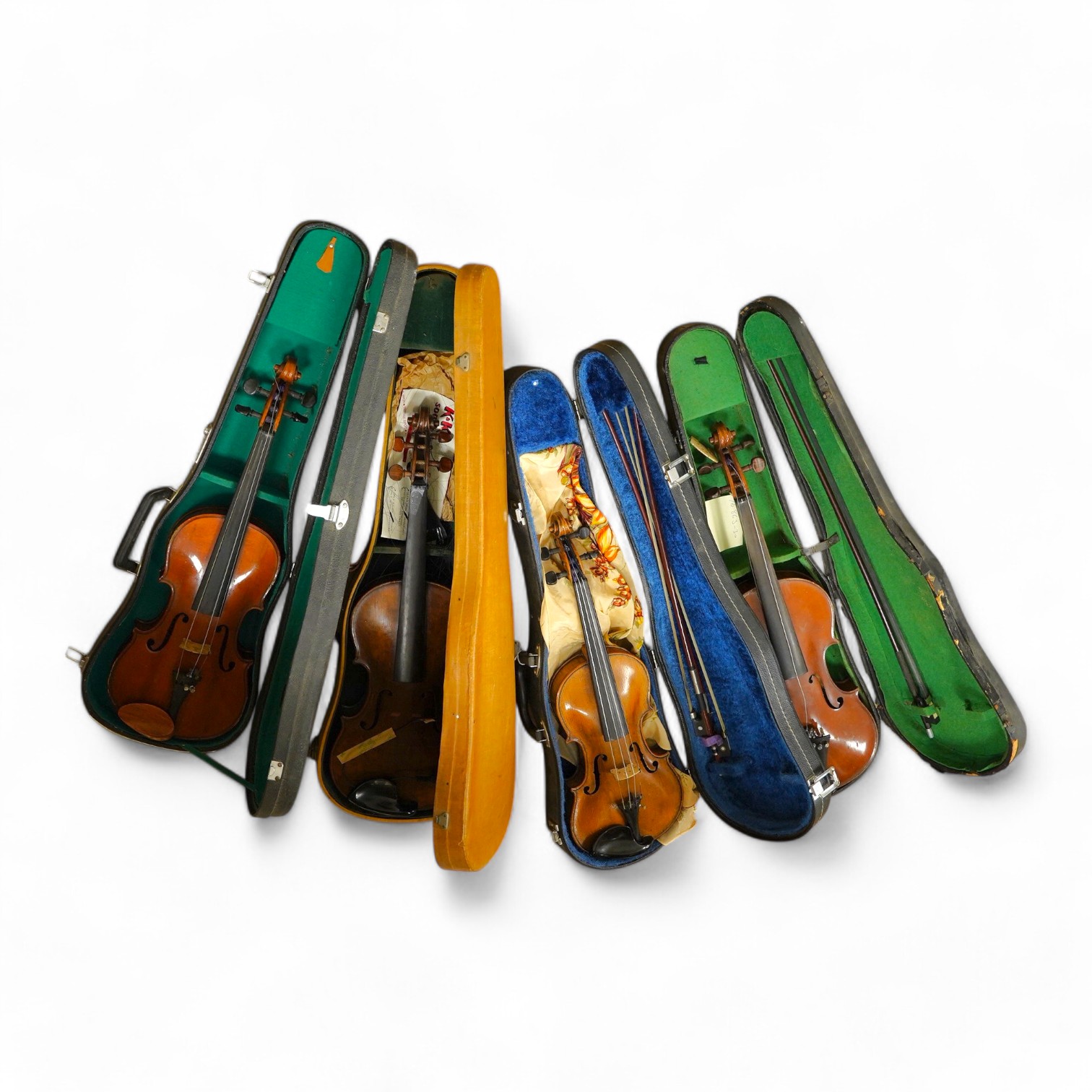 Four cased violins; an early 20th century violin, body 36cm, fitted with a microphone pick up taking a quarter inch jack plug, an early 20th century half size violin, body 32cm, and two student violins. Condition - poor